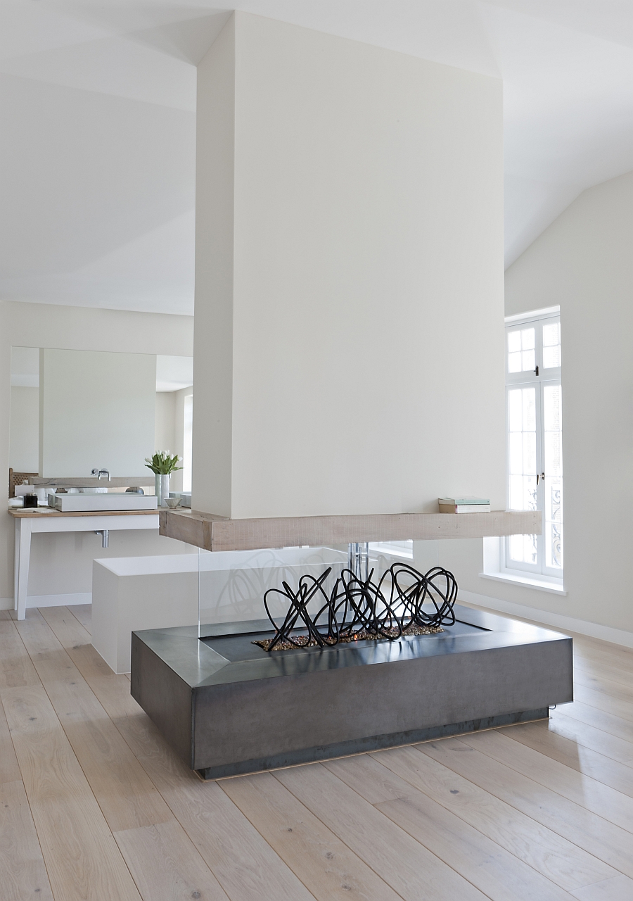 Two sided Sculptural fireplace in the spa-like bathroom