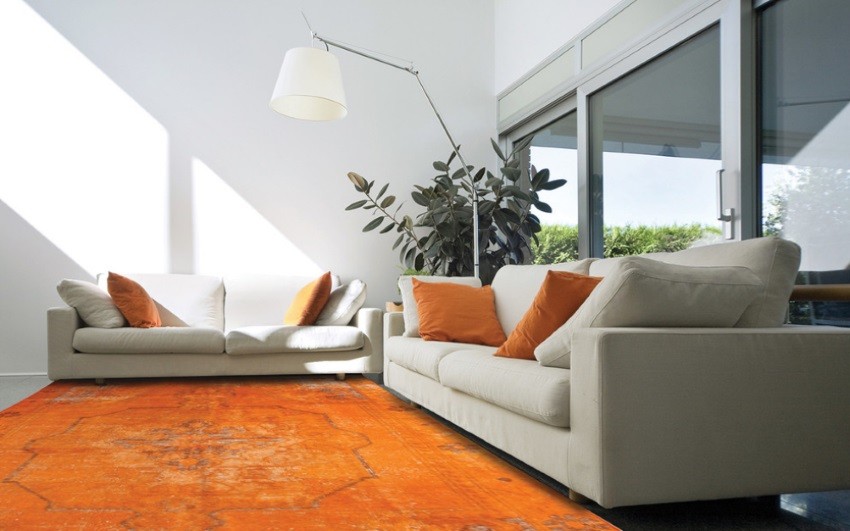 White living room with an orange overdyed rug