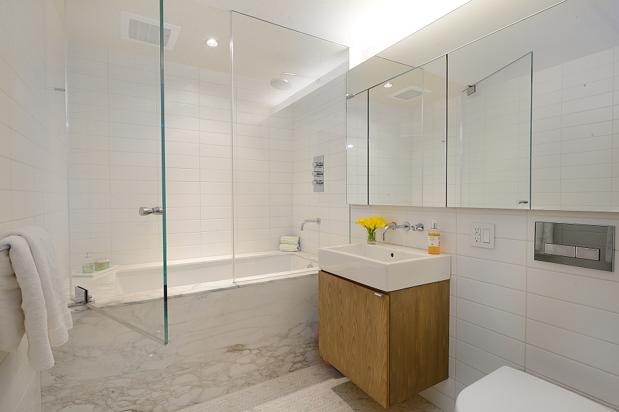 Wooden floating vanity adds visual warmth to the bathroom