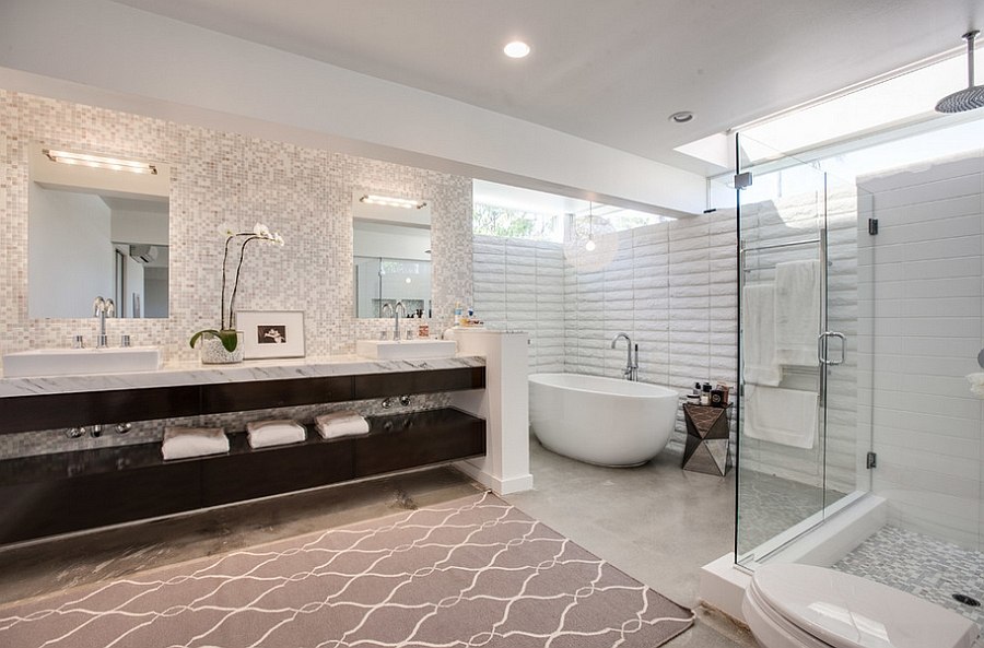 master bathroom with dual sinks, glass shower area and a standing bathtub in the corner