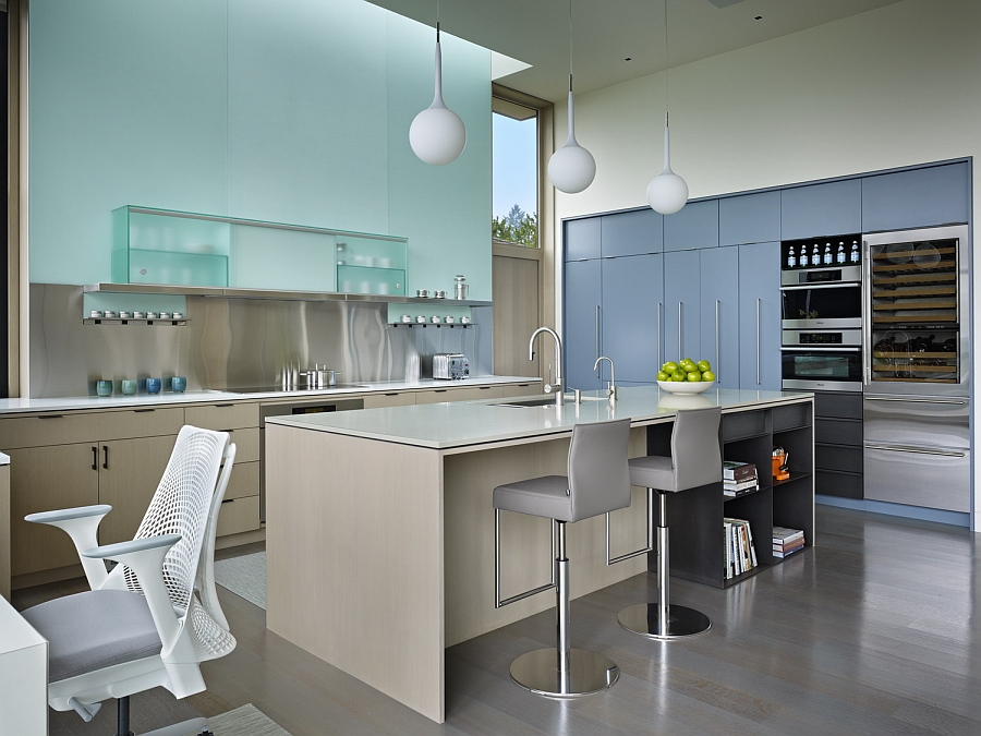 Backpainted glass panels in light green add glamor to the kitchen