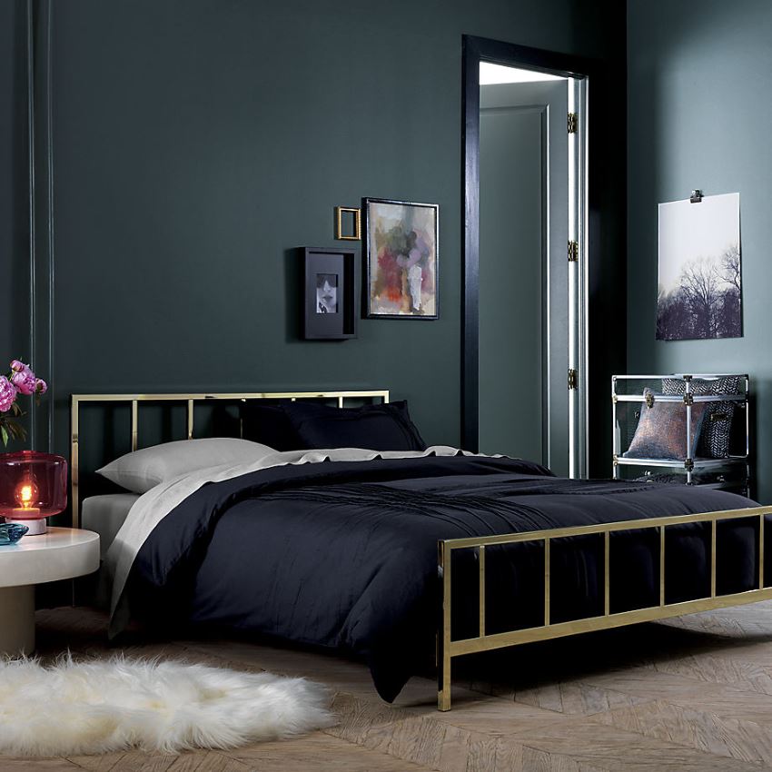 Brass bed in a dark room