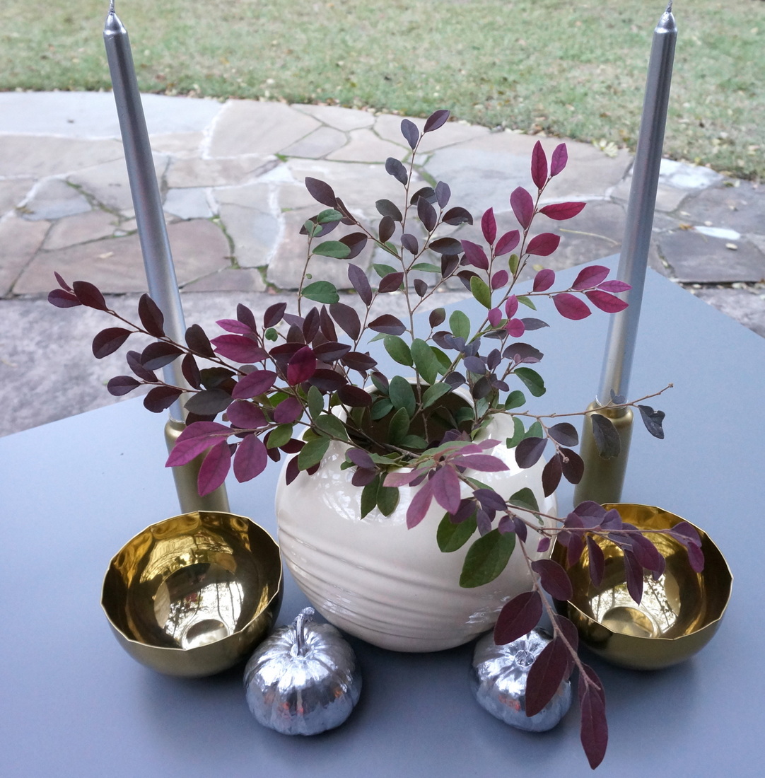 Brass candleholders and bowls add a warm glow to the table