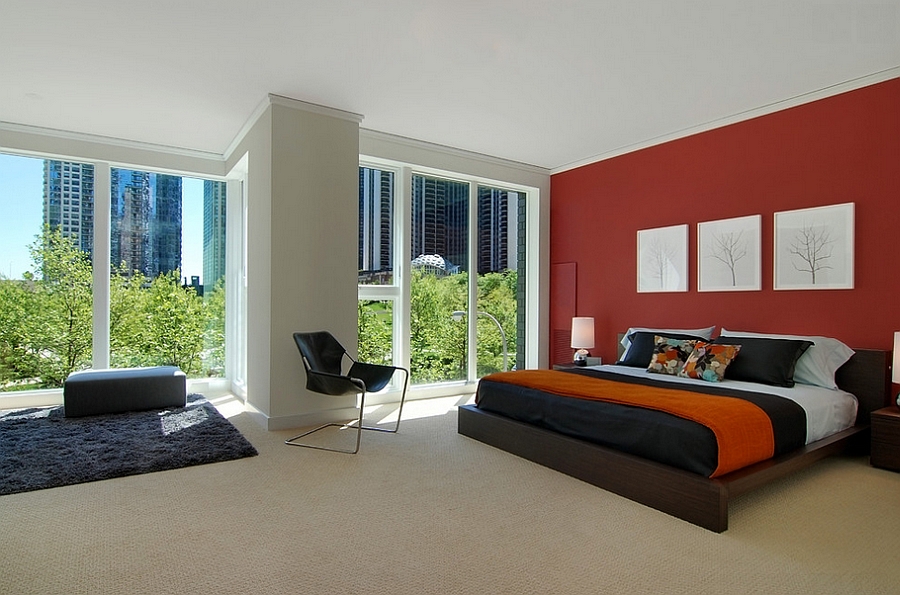 red accent wall bedroom with black furniture