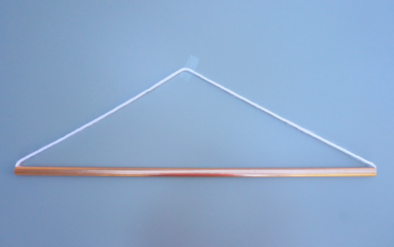 Copper tubing and yarn form the base of the wall hanging
