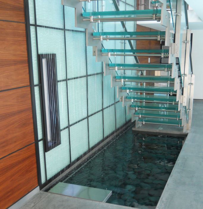 Custom rain curtain next to a contemporary staircase