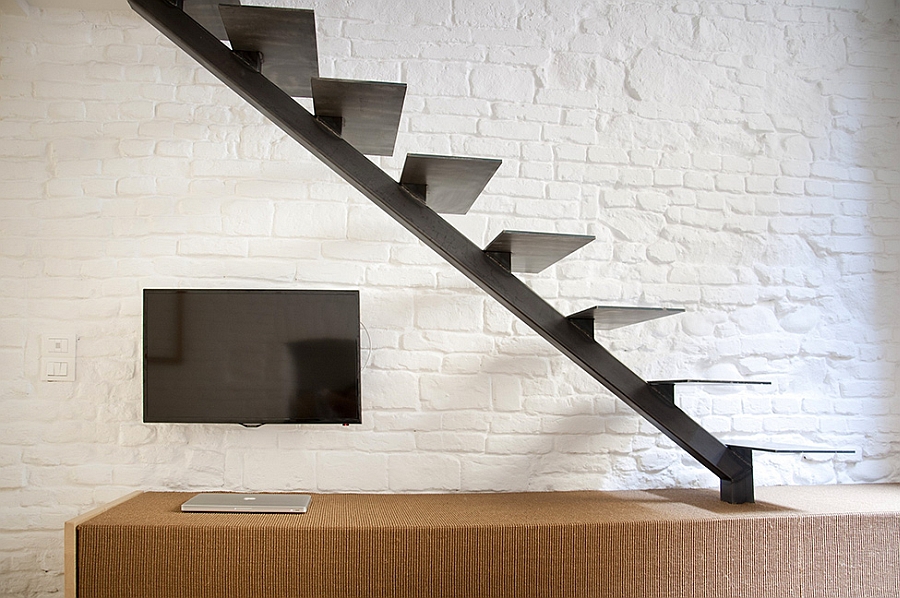 Dark sculptural staircase leading to the top level