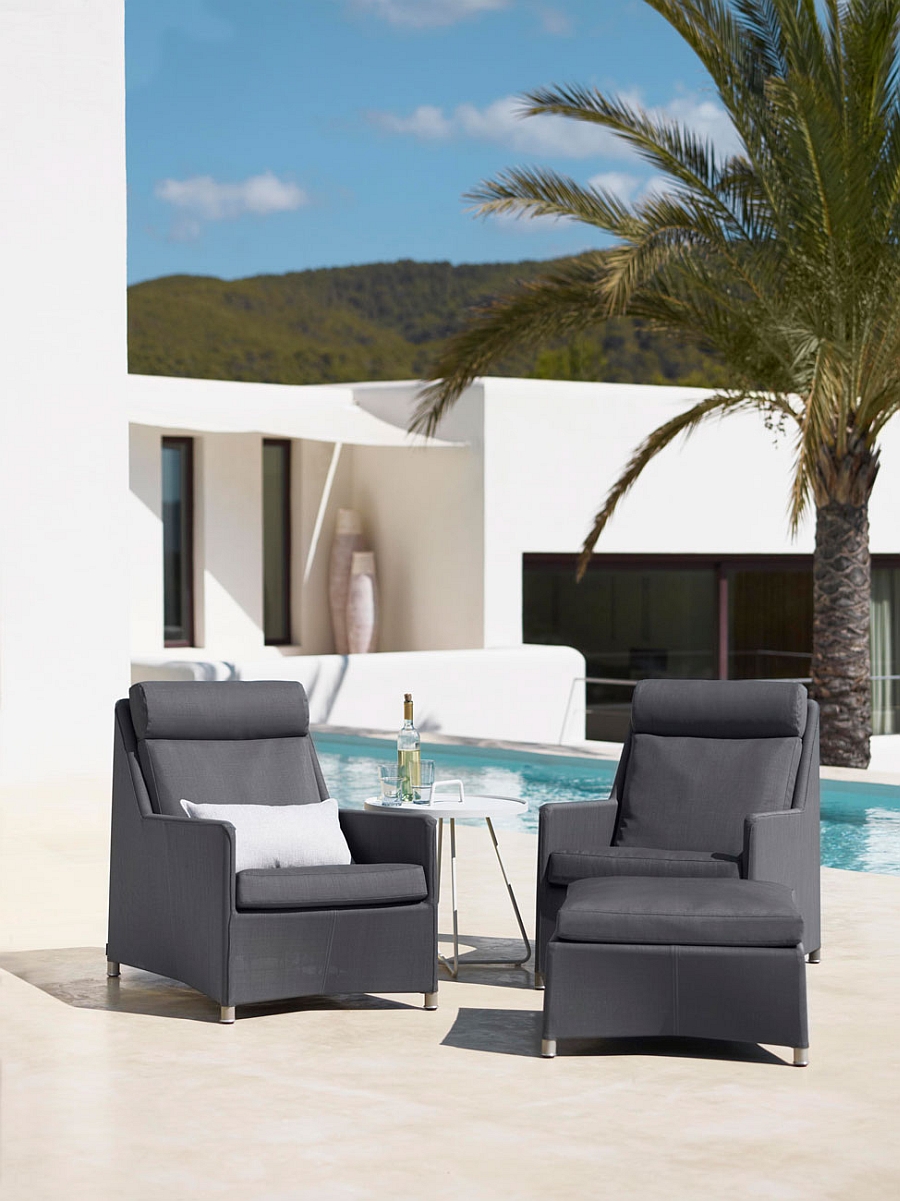 Diamond highback outdoor chairs with footstool next to the pool