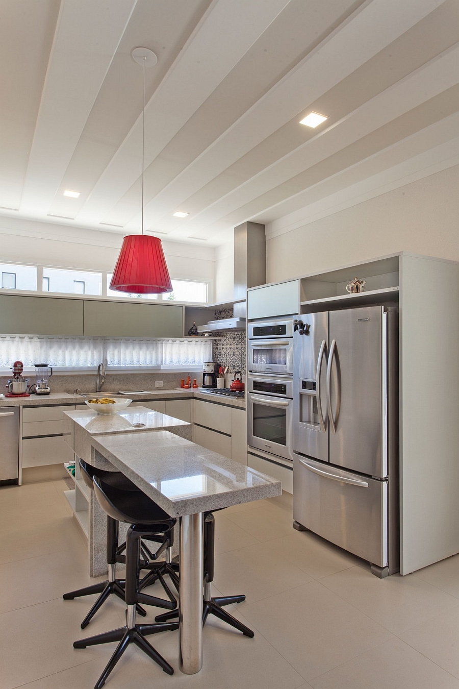 Ergonomic contemporary kitchen with bold pendant light in red