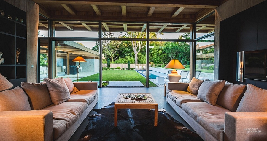 Glass doors and windows connect the living area with the backyard