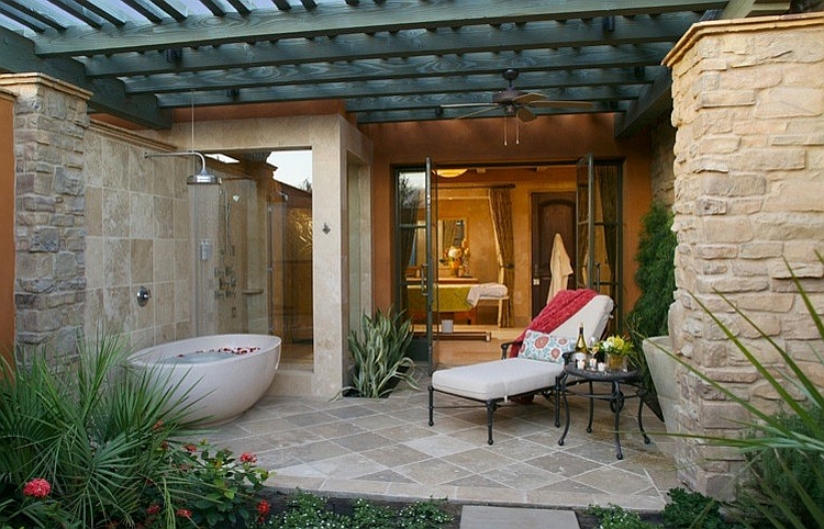 Outdoor bathtub and shower adjacent to the bathroom indoors