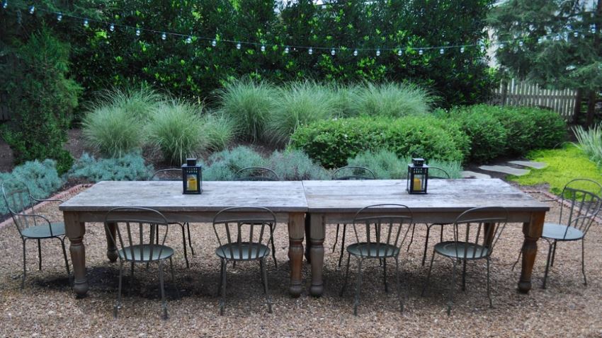 Outdoor dining space surrounded by lush greenery