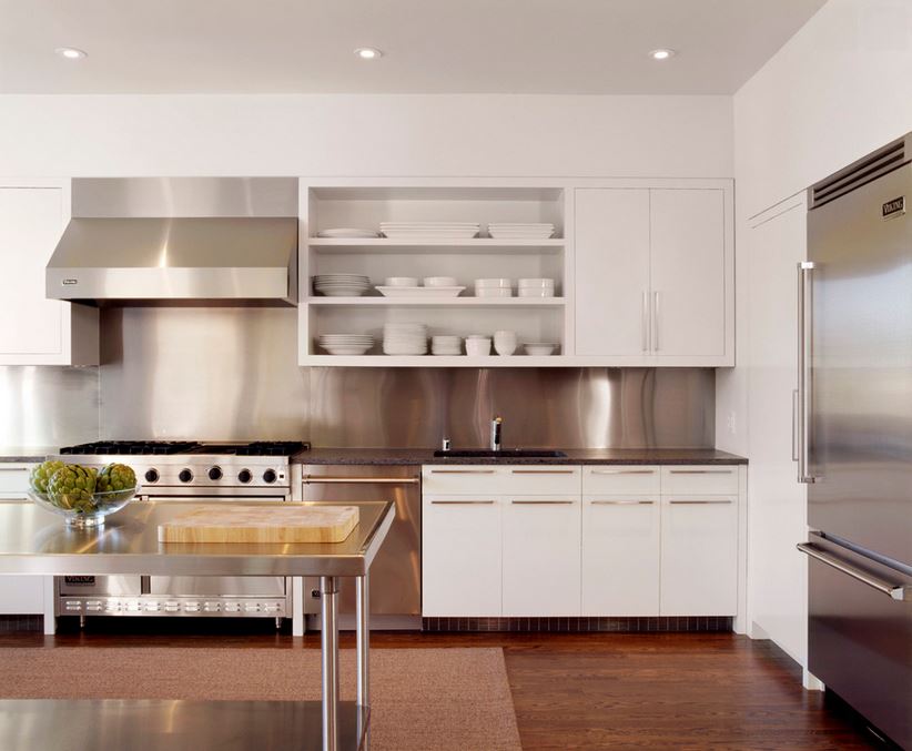 Sleek white dishes on open shelving in a white kitchen