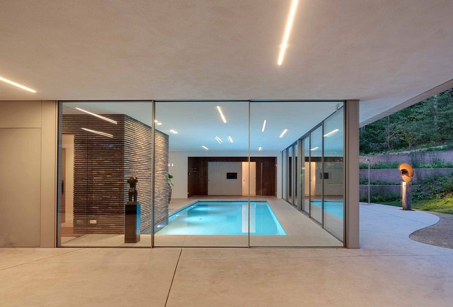 Sliding glass doors connect the pool with the outdoors