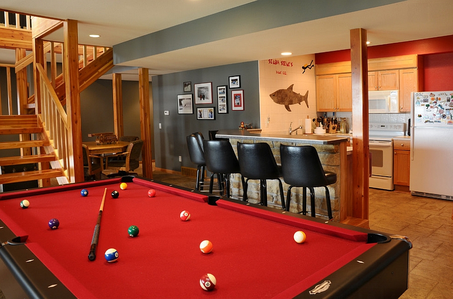 Trendy use of gray and red in the stylish basement bar