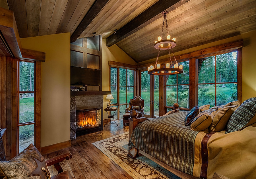Woodsy cabin style bedroom with a fireplace