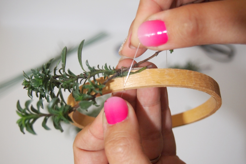 attaching the herb to the wreath form