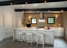 All-white-kitchen-island-and-countertop-with-a-backdrop-in-earthen-hue-217x155