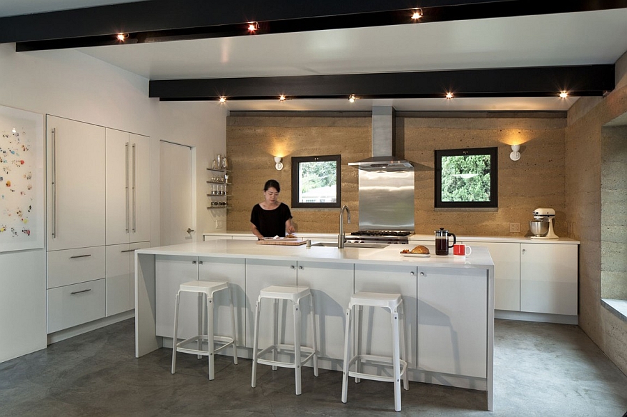 All-white kitchen island and countertop with a backdrop in earthen hue