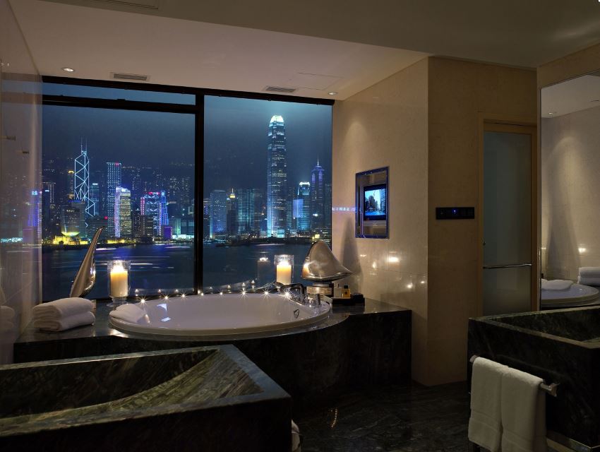 Bathroom with lit candles and a city view