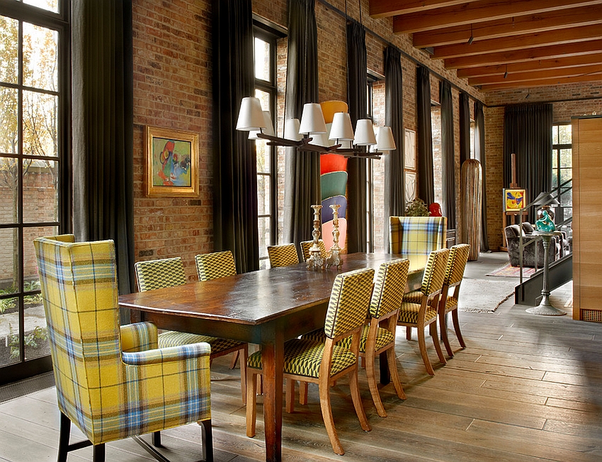 Chairs add a touch of yellow to the industrial dining room