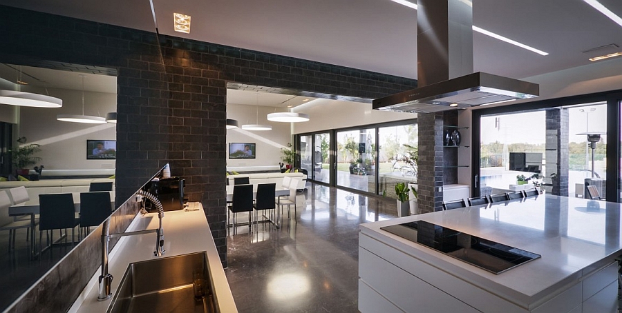 Dark kitchen walls and white countertops create a posh space