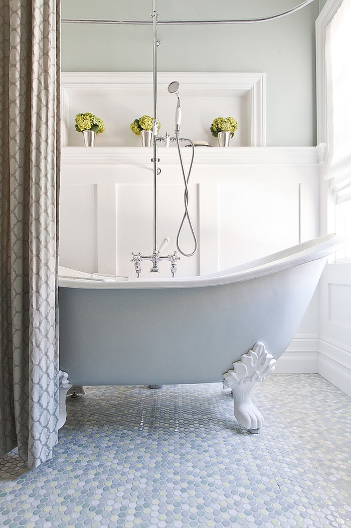 Elegant bathroom with claw-foot bathtub and mulitcolored penny tile flooring