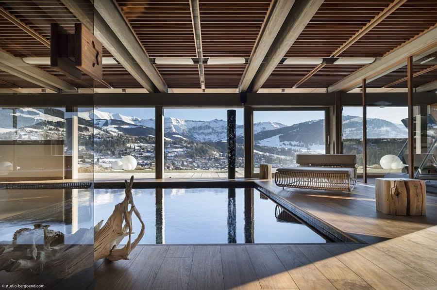 Expansive indoor pool with jet streams and a view of the snow-covered Alps