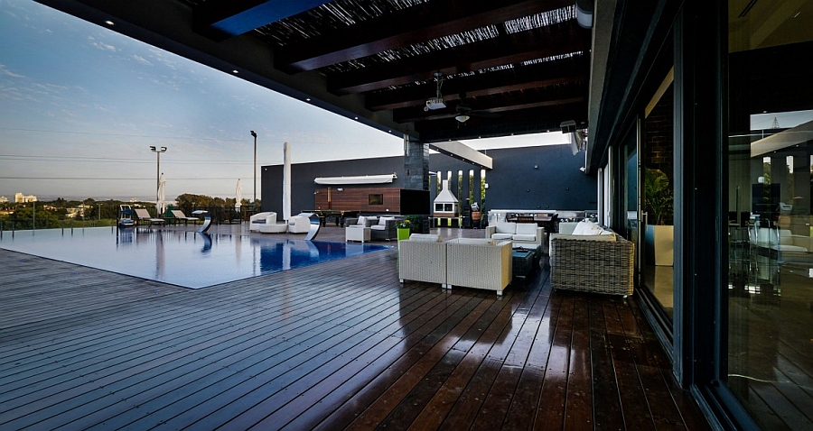 Expansive wooden deck of the luxurious penthouse with pool