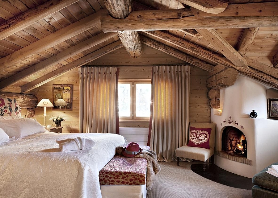 Exposed wooden beams and a rustic cabin look inside the bedroom