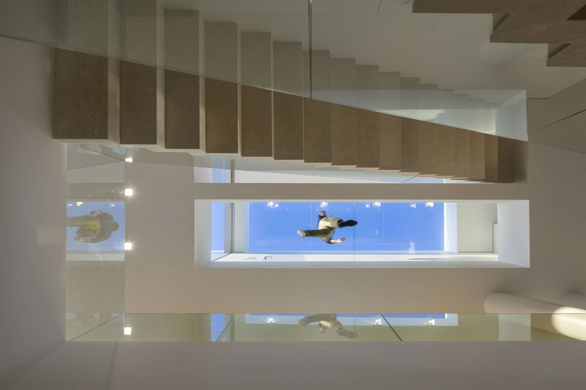 Glass walkway on the top floor viewed from the ground level of the house