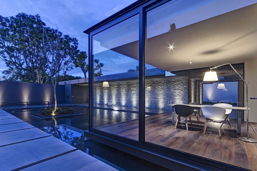 Home studio cantilevered above the tranquil pool