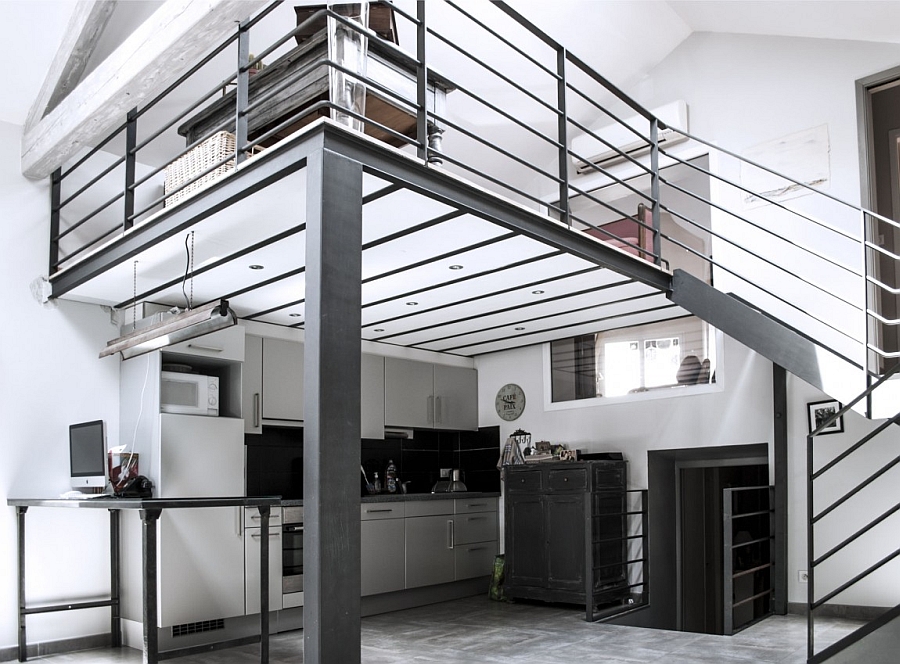 Kitchen nestled beneath the overhang of the top level