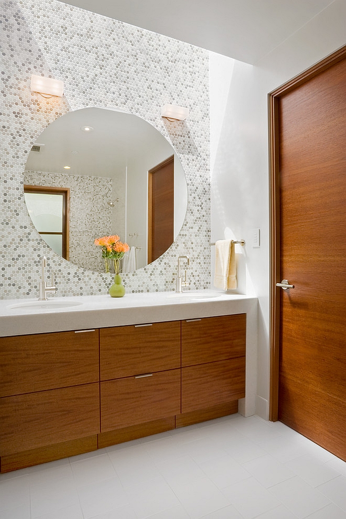 Large round mirror above the bathroom vanity