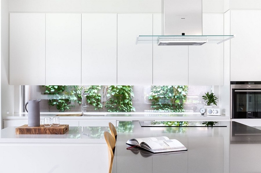 Minimal style cabinets and a wide window give the kitchen a modern appeal