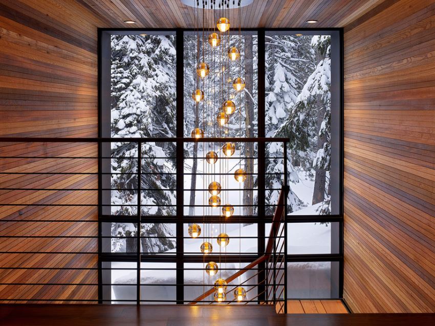 Modern staircase with a snowy wooded view