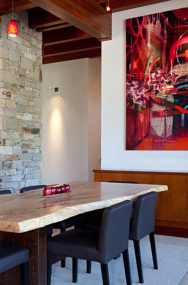 Natural stone dining table and fiery reds in the dining room