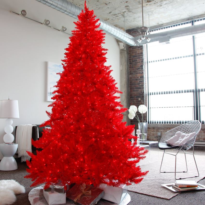 Red pre-lit Christmas tree in a neutral modern space