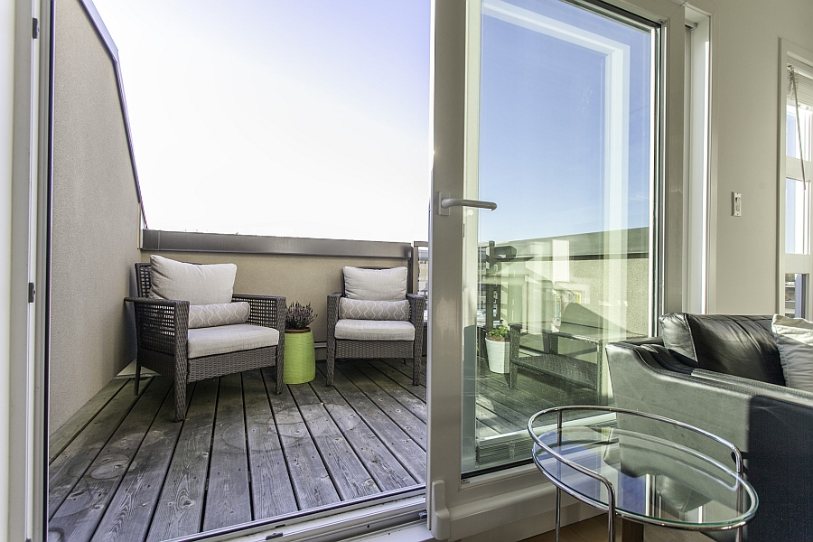 Sliding glass doors connecting the living room with the balcony