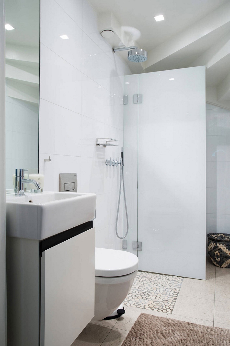 Small shower area in the white bathroom