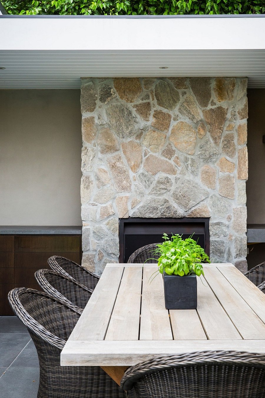 Stone fireplace acts as the perfect backdrop for the alfresco dining