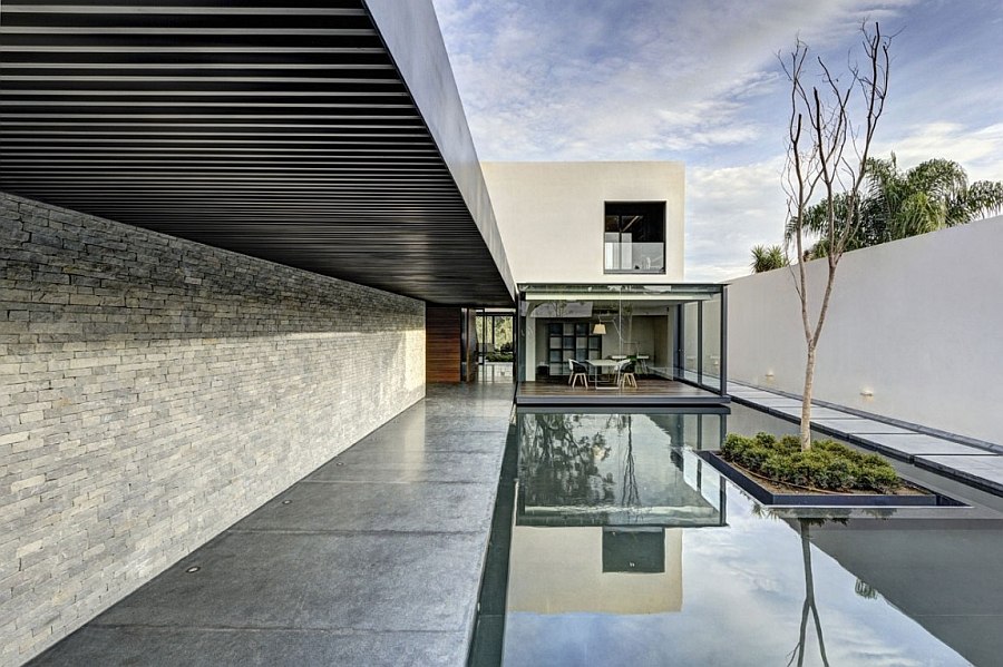 Tranquil pool leading to the living area of the house