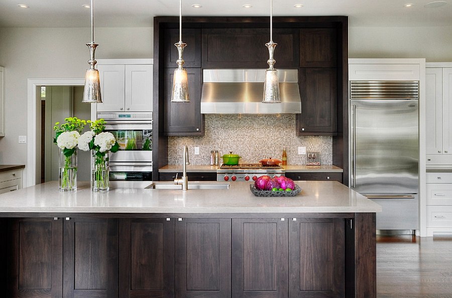 Trendy kitchen with Shaker style doors and drawers in walnut