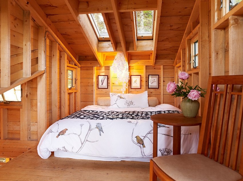 Twin skylights give the small attic bedroom a roomy appeal [Design: David Matero Architecture]