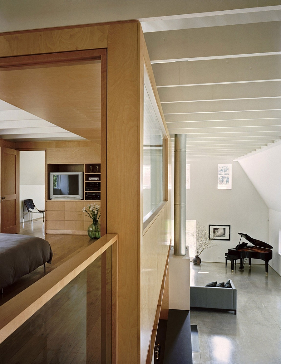 View of the bedroom on the loft level and the living area below