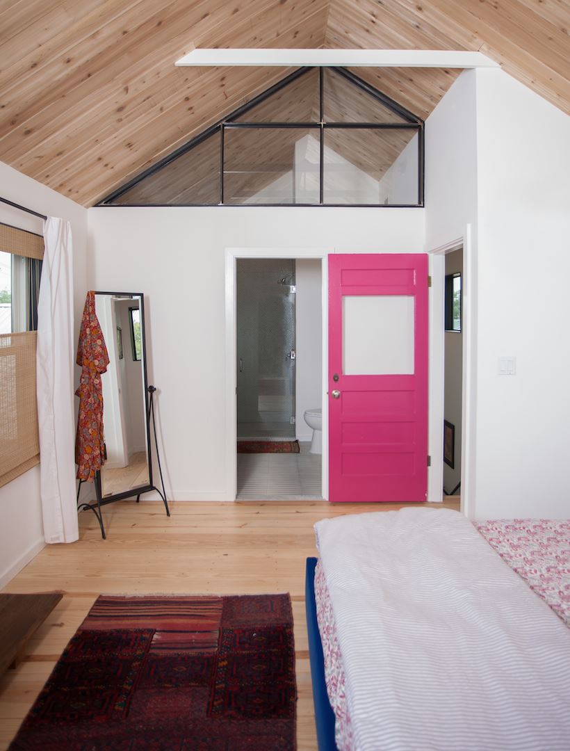 A pink door makes a bold statement in the bungalow of Ashton Arthur (photo by Jessica Pages)