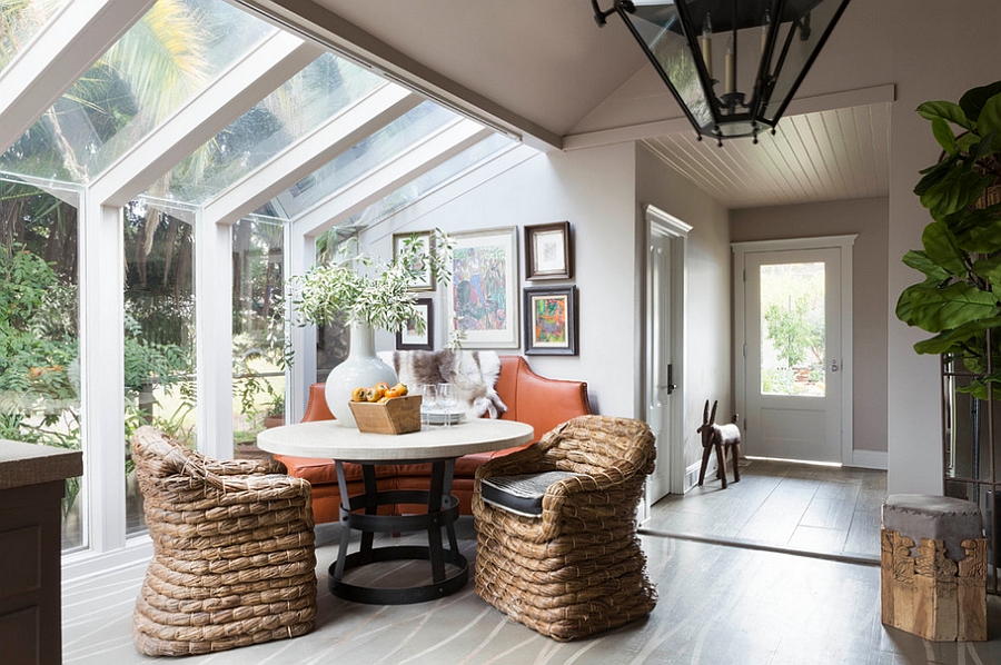 A wall of glass brings the greenery outside into the dining room