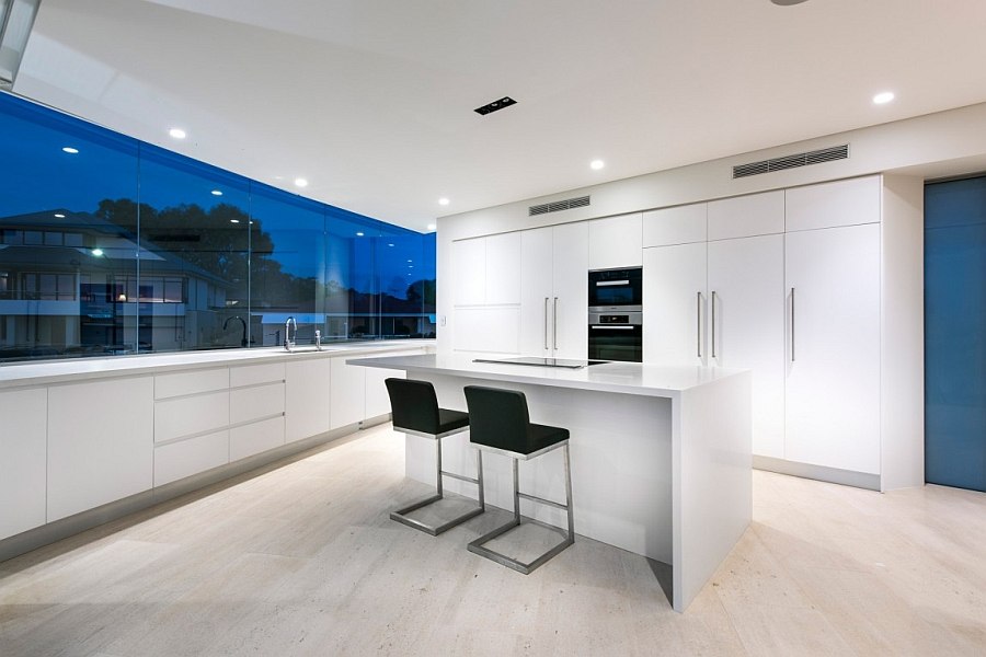 All-white contemporary kitchen with large glass windows
