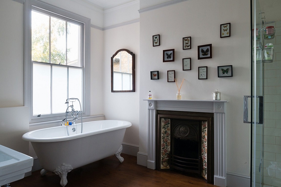 Bathroom with a claw-foot bathtub and a gallery wall