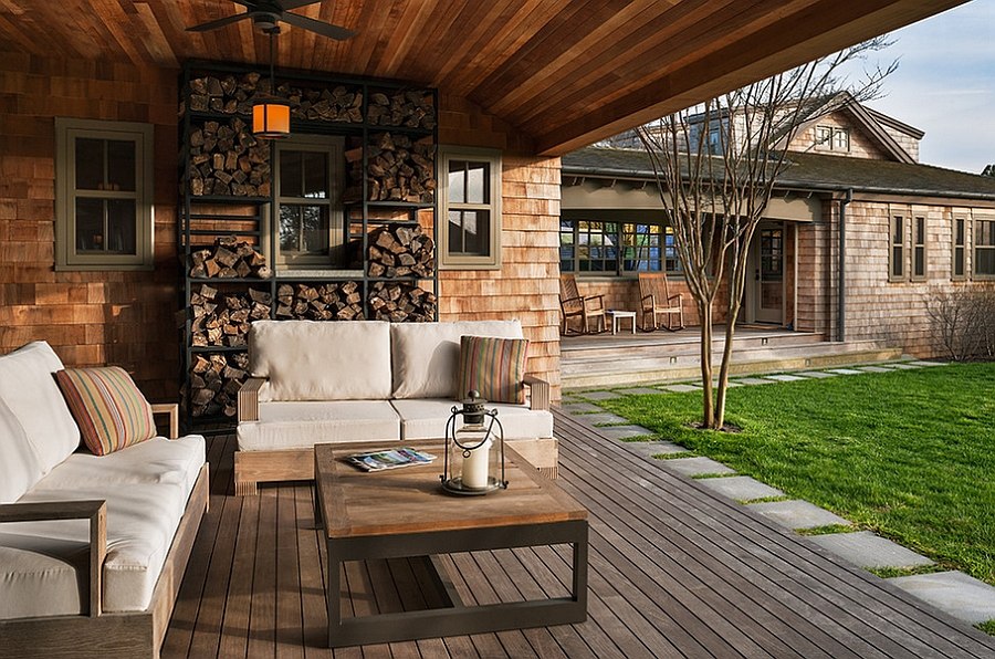 Beach style porch has ample space for firewood storage